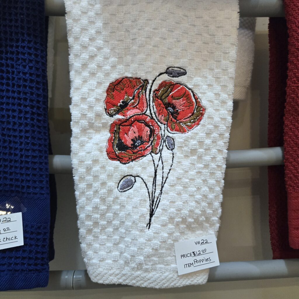Embroidered deco style red poppy flowers on waffle bathroom handtowel