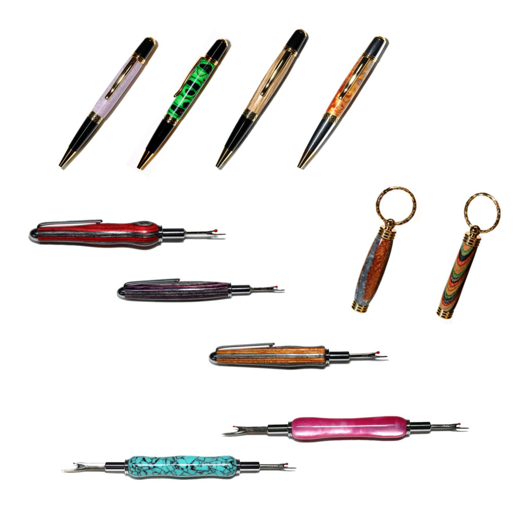 Assorted woodturning pens, keychains, letter openers, seam rippers. Acrylic, wood, metal